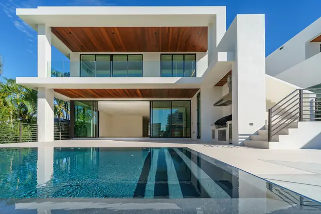 Twilight view of a modern residence with a still pool — the kind of door JD Prime Properties prepares to show.