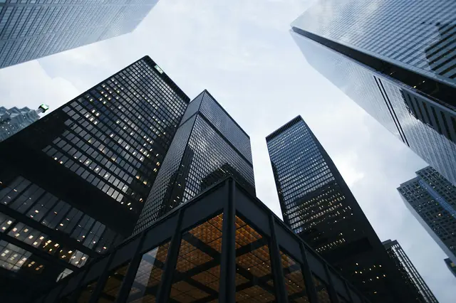 City towers at dusk — hold-or-list conversations for owners.